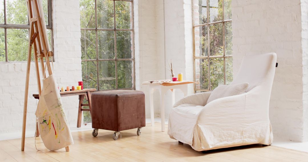 Spacious Art Studio with White Armchair and Rustic Details