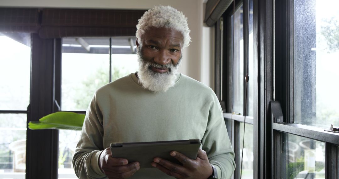 Senior Man Embracing Technology with Tablet and Smartwatch