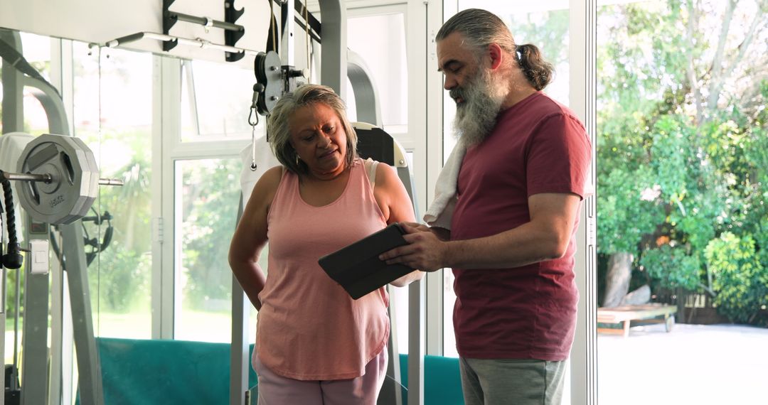 Senior Couple Energized by Customized Fitness Plan at Home Gym