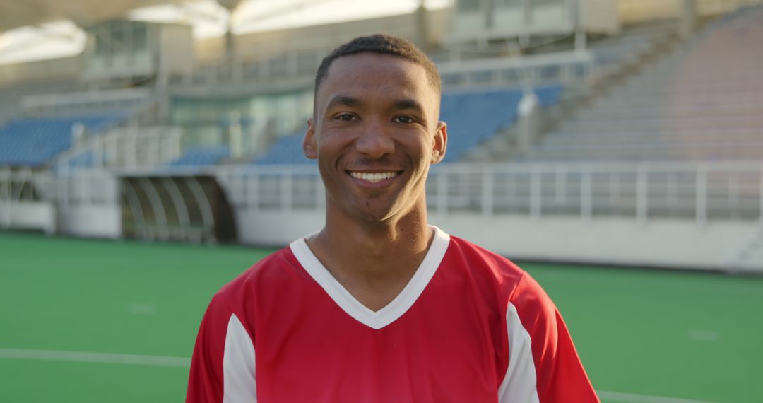 Confident Young Soccer Player Smiling on Field - Free Images, Stock Photos and Pictures on Pikwizard.com