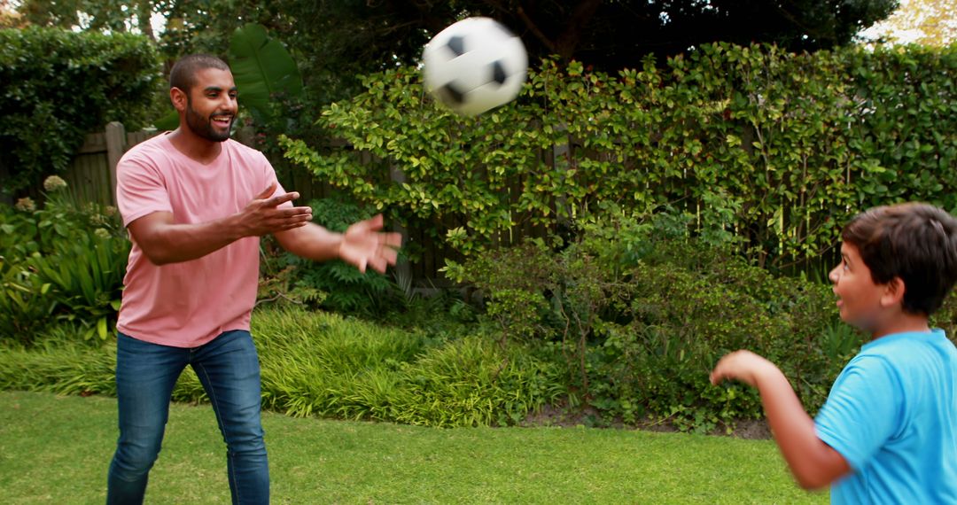 Father and Son Enjoy Soccer Game in Backyard - Free Images, Stock Photos and Pictures on Pikwizard.com