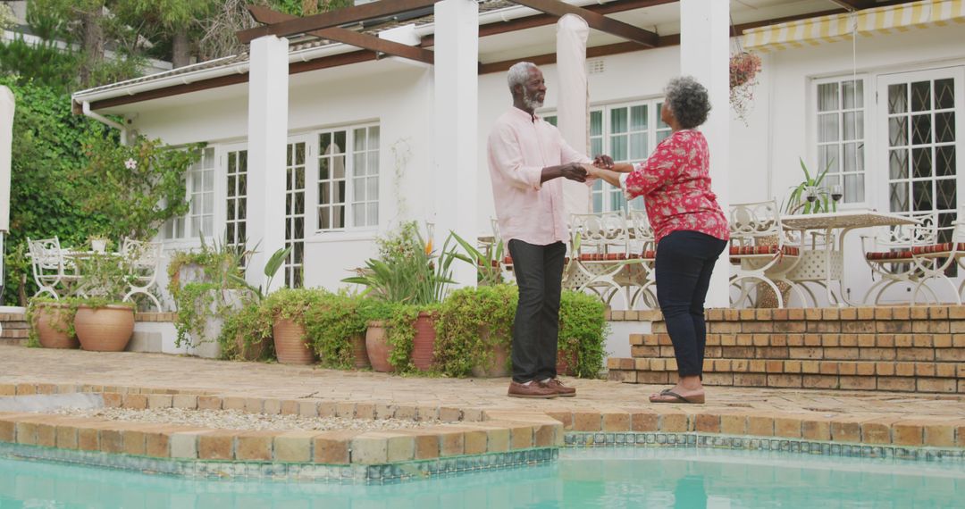 Senior Couple Dancing by Swimming Pool on Sunny Day - Free Images, Stock Photos and Pictures on Pikwizard.com