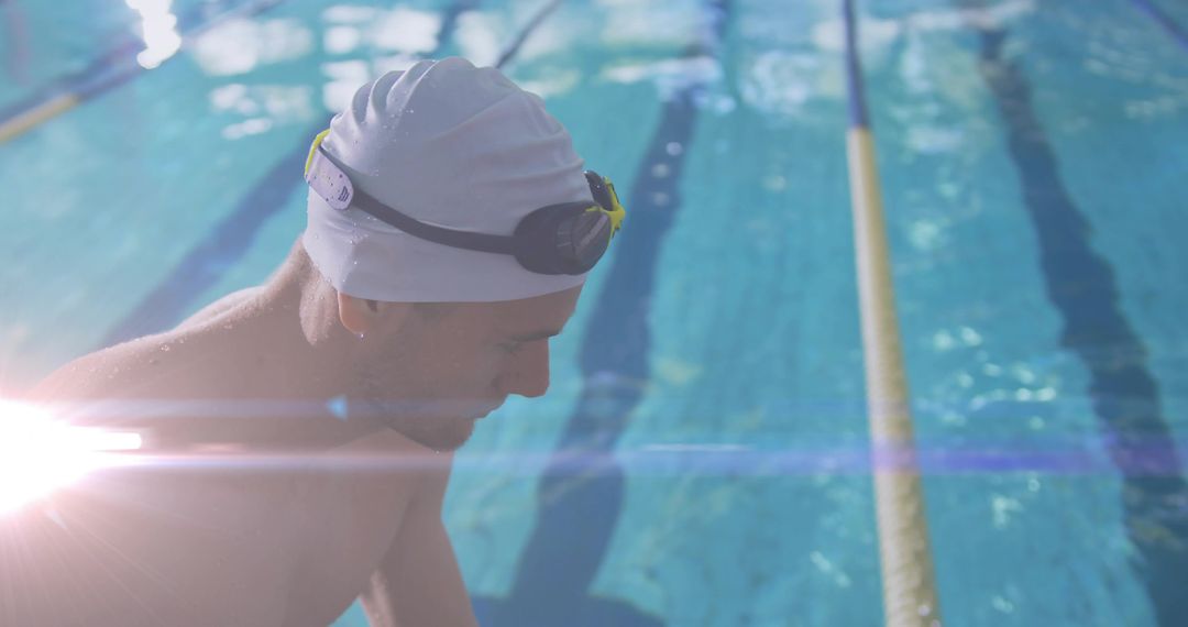 Focused Swimmer at Poolside in Bright Sunlight