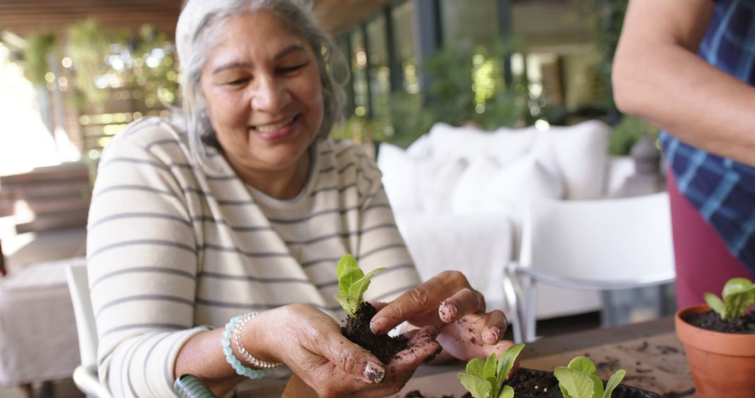 Senior Woman Smiling While Gardening on Patio - Free Images, Stock Photos and Pictures on Pikwizard.com