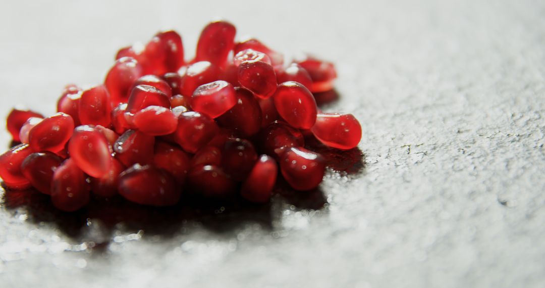 Close-Up of Fresh Pomegranate Seeds on Textured Surface - Free Images, Stock Photos and Pictures on Pikwizard.com