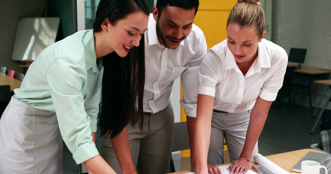 Architectural Team Collaborating on Project Plans in Modern Office