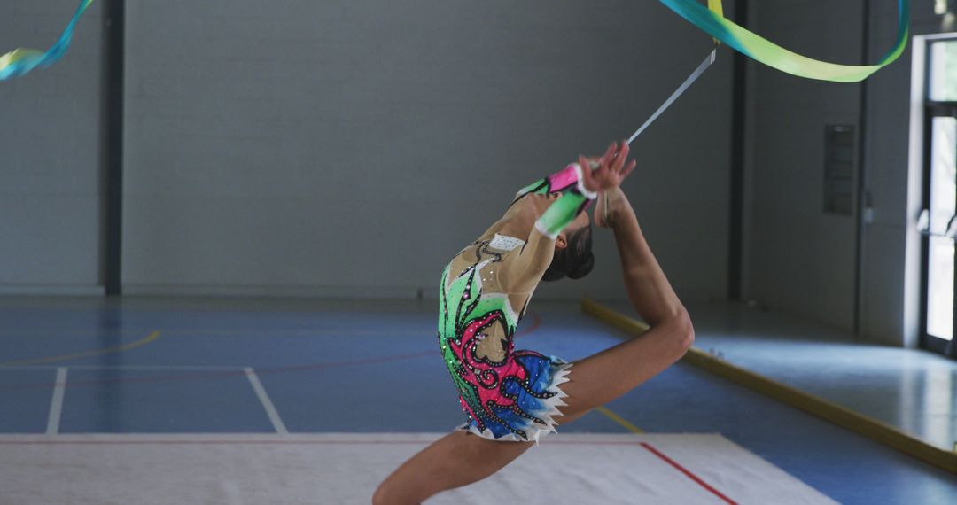 Graceful Gymnast Performing Ribbon Dance Routine Indoors - Free Images, Stock Photos and Pictures on Pikwizard.com