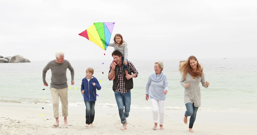 Happy Multigenerational Family Flying Kite on Beach - Free Images, Stock Photos and Pictures on Pikwizard.com