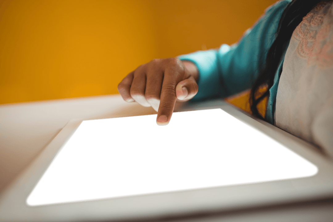Hand Interacting with Transparent Tablet Surface in Modern Setting