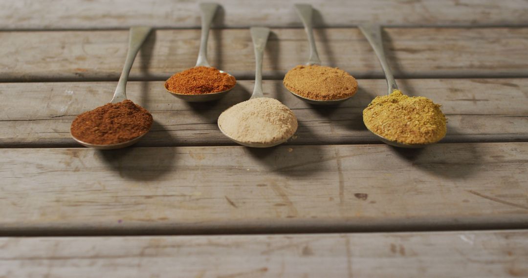 Assorted Colorful Spices in Spoons on Wooden Table - Free Images, Stock Photos and Pictures on Pikwizard.com