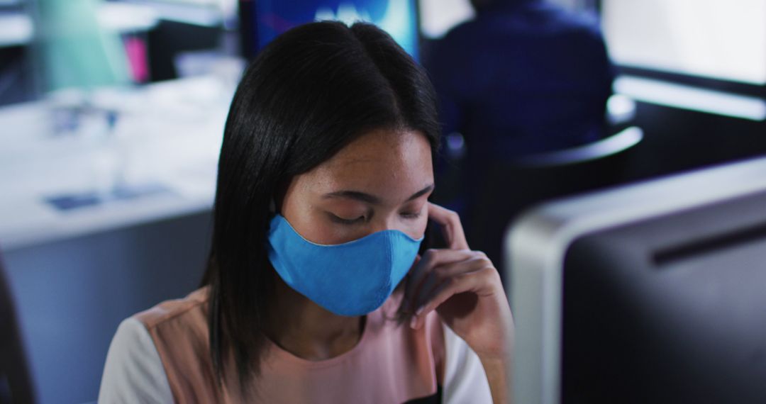 Woman with Blue Face Mask Using Smartphone in Office - Free Images, Stock Photos and Pictures on Pikwizard.com