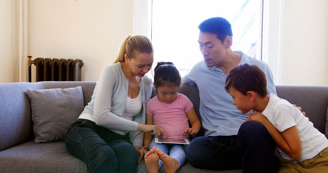 Multiracial Family Enjoying Time Together with Tablet at Home