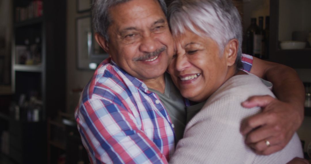 Elderly Couple Embracing With Joyful Smiles at Home - Free Images, Stock Photos and Pictures on Pikwizard.com