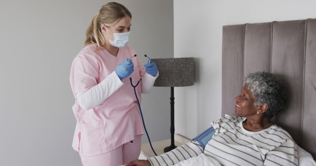 Nurse examining elderly female patient in hospital room - Free Images, Stock Photos and Pictures on Pikwizard.com