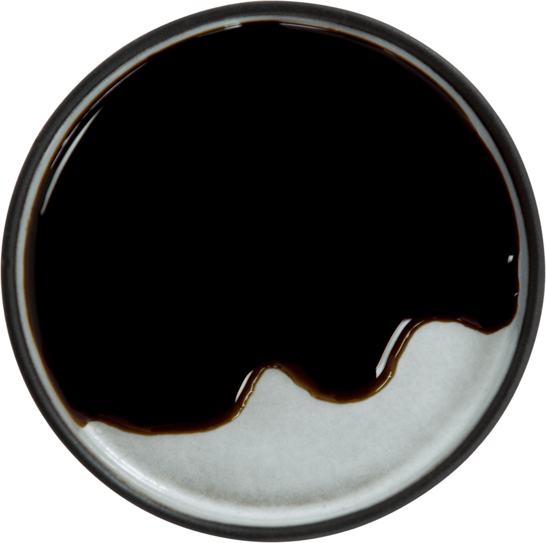 Transparent Plate with Glossy Soy Sauce on White Background