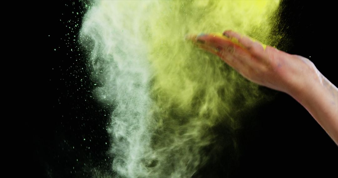 Hand Throwing Yellow Powder in Dark Background - Free Images, Stock Photos and Pictures on Pikwizard.com