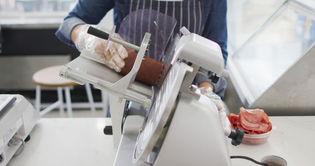 Image of hands of biracial waitress using meat cutting machine - Free Images, Stock Photos and Pictures on Pikwizard.com