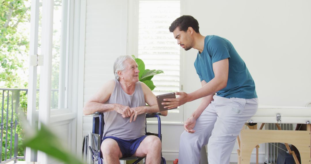 Caregiver Helping Senior Man in Wheelchair with Digital Tablet - Free Images, Stock Photos and Pictures on Pikwizard.com