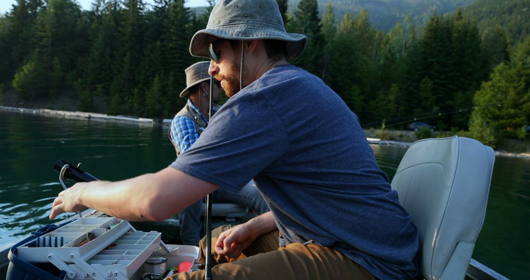 Men Fishing on Lake in Mountainous Forest in Late Afternoon - Free Images, Stock Photos and Pictures on Pikwizard.com