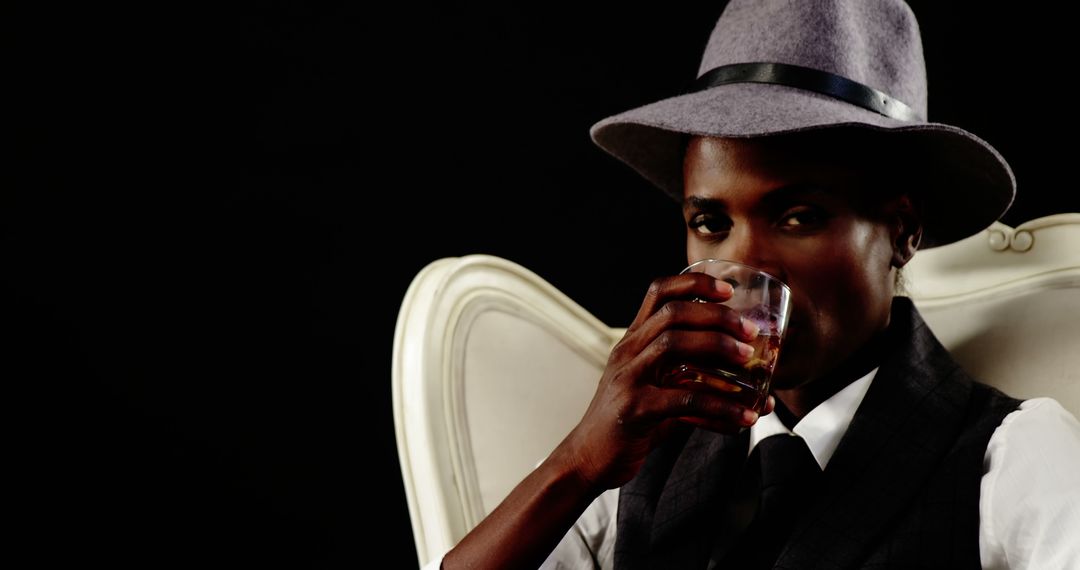 Stylish African American Man Drinking Whiskey in Sophisticated Setting - Free Images, Stock Photos and Pictures on Pikwizard.com