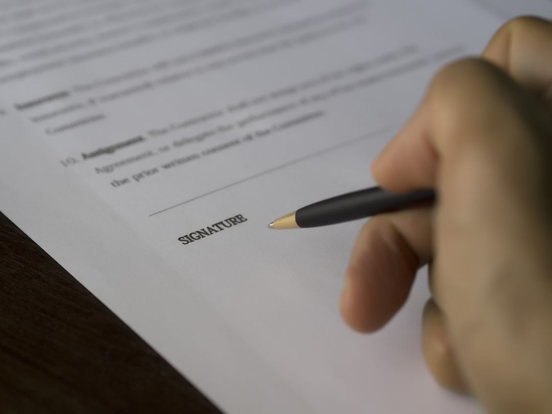 Close-Up of Hand Signing a Document with a Pen - Free Images, Stock Photos and Pictures on Pikwizard.com