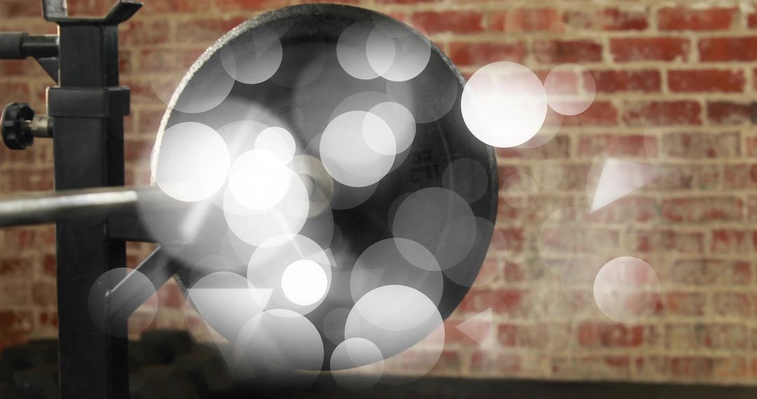 Industrial gong with brick wall backdrop and soft bokeh light reflections, workshop