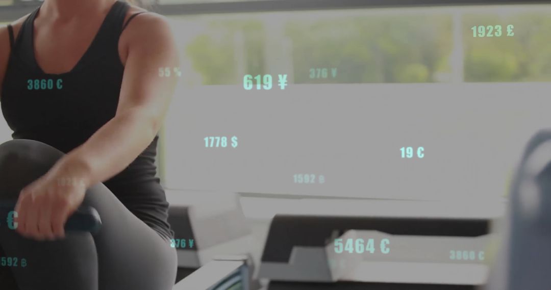 Woman Using Rowing Machine with Currency Data Overlay in Modern Gym