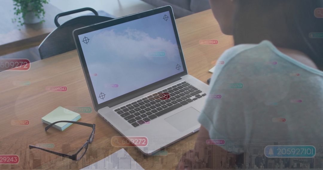 Woman Typing at Office Table with Digital Data Overlays