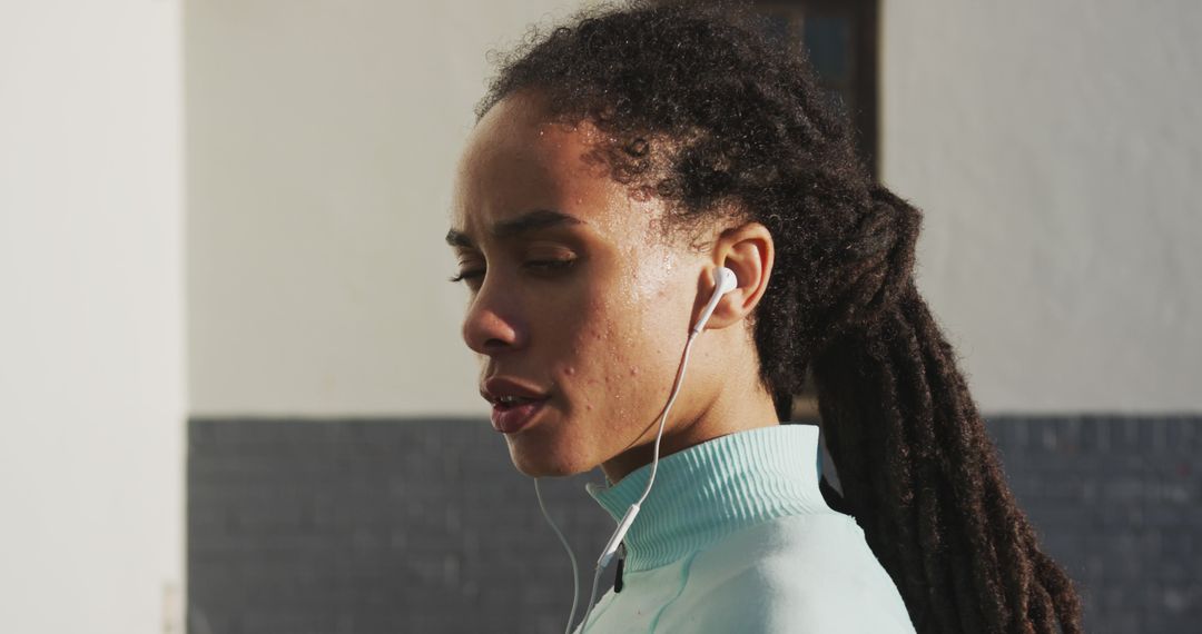 Young Woman with Earphones Pausing During Outdoor Run - Free Images, Stock Photos and Pictures on Pikwizard.com