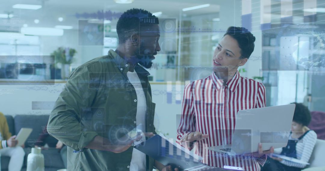 Diverse Coworkers Analyzing Digital Reports in Modern Office