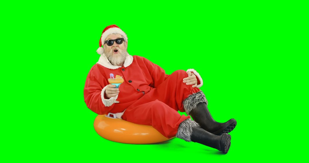 Hip Santa Relaxing on Inflatable Tube with Cocktail on Green Screen - Free Images, Stock Photos and Pictures on Pikwizard.com