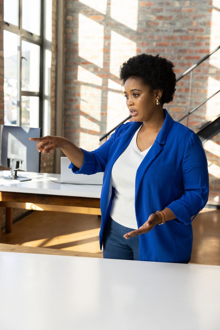 Professional Woman In Loft Office Showing Assertive Expression