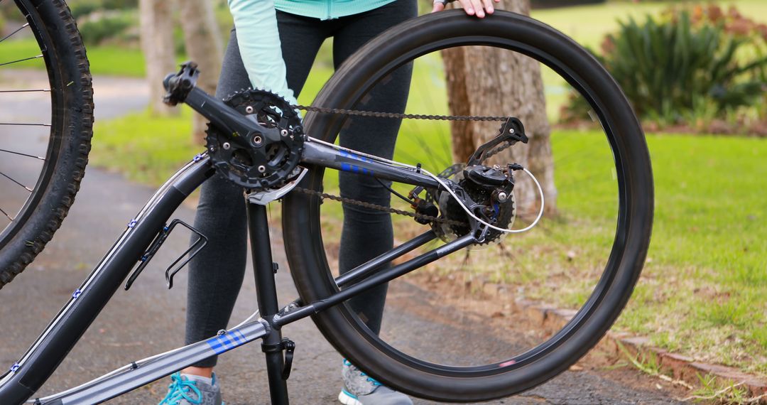 Woman Fixing Bicycle Chain Outdoors - Free Images, Stock Photos and Pictures on Pikwizard.com