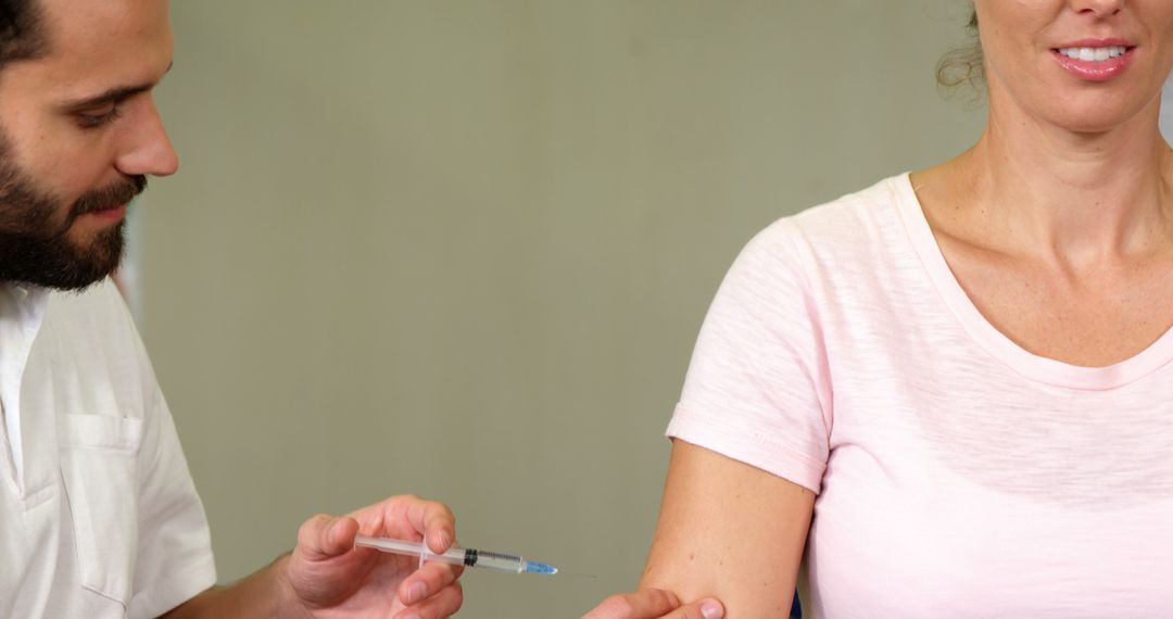 Healthcare Professional Administering Injectable Vaccine to Patient - Free Images, Stock Photos and Pictures on Pikwizard.com