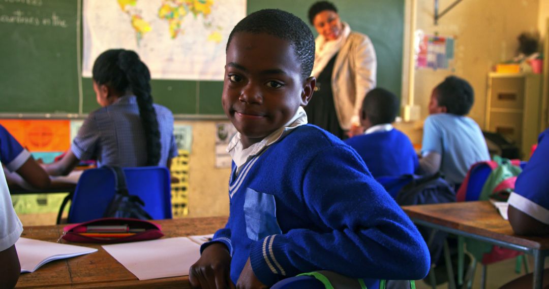 Smiling Schoolboy in Classroom with Classmates and Teacher - Free Images, Stock Photos and Pictures on Pikwizard.com