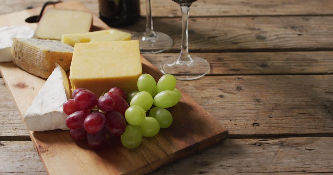 Rustic Cheese Board with Grapes and Wine on Wooden Table - Free Images, Stock Photos and Pictures on Pikwizard.com