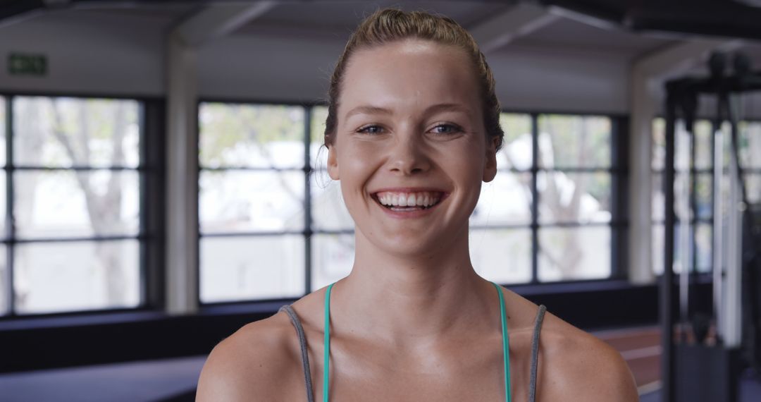 Smiling Young Woman in Gym Setting - Free Images, Stock Photos and Pictures on Pikwizard.com