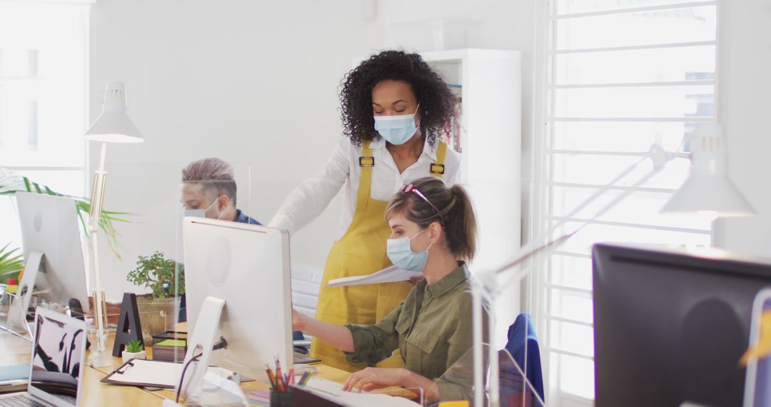 Masked Colleagues Collaborating in Modern Office Environment
