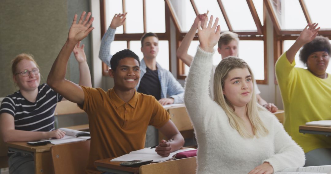 Engaged students raising hands in diverse high school classroom - Free Images, Stock Photos and Pictures on Pikwizard.com