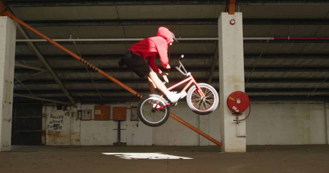 BMX Rider Performing Stunt in Abandoned Warehouse - Free Images, Stock Photos and Pictures on Pikwizard.com