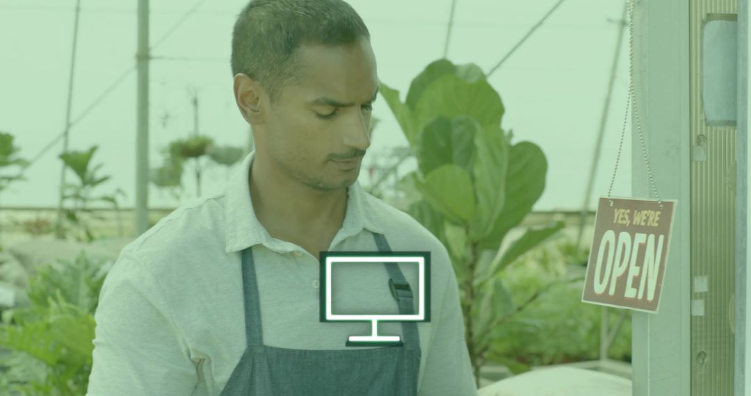 Nursery Worker at Greenhouse Entrance Holding Open Sign