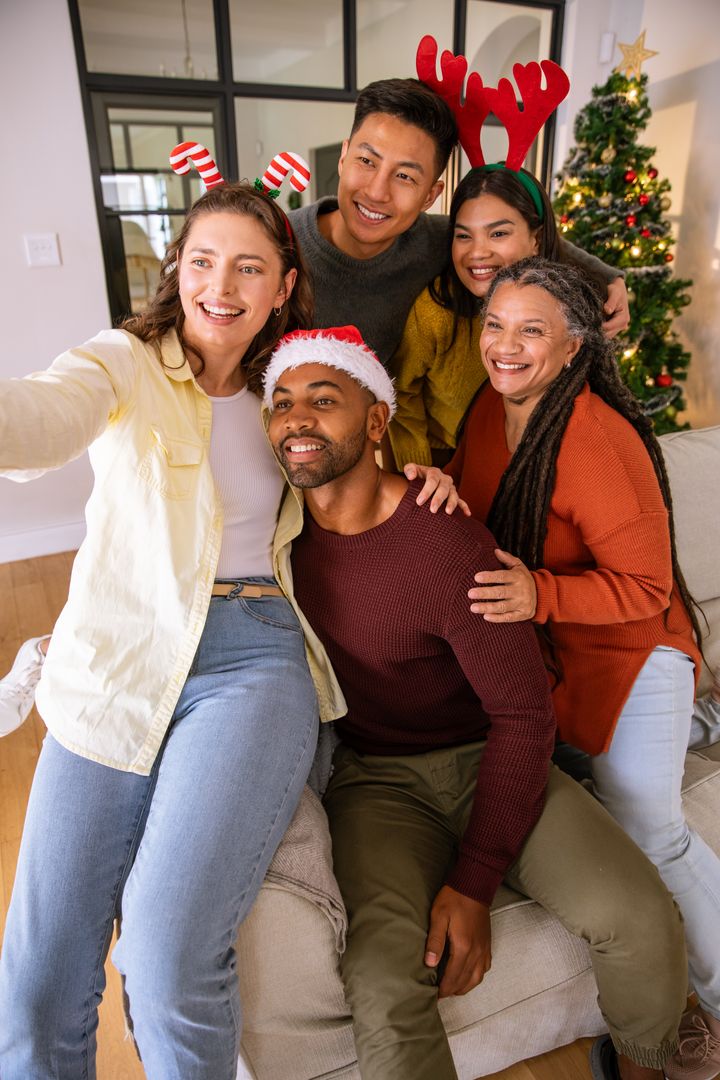 Diverse Friends Taking Festive Selfie by Christmas Tree