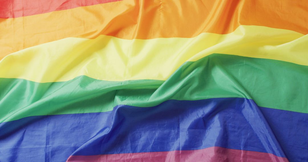 Image of creased rainbow flag lying on white background - Free Images, Stock Photos and Pictures on Pikwizard.com