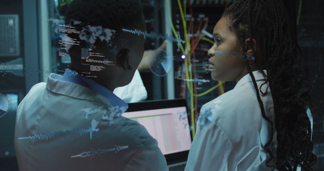 IT Technicians Analyzing Data in Server Room Environment