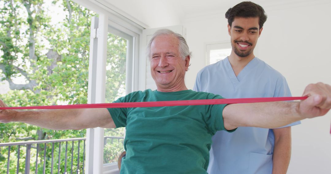 Senior Man Exercising with Resistance Band Assisted by Young Caregiver - Free Images, Stock Photos and Pictures on Pikwizard.com