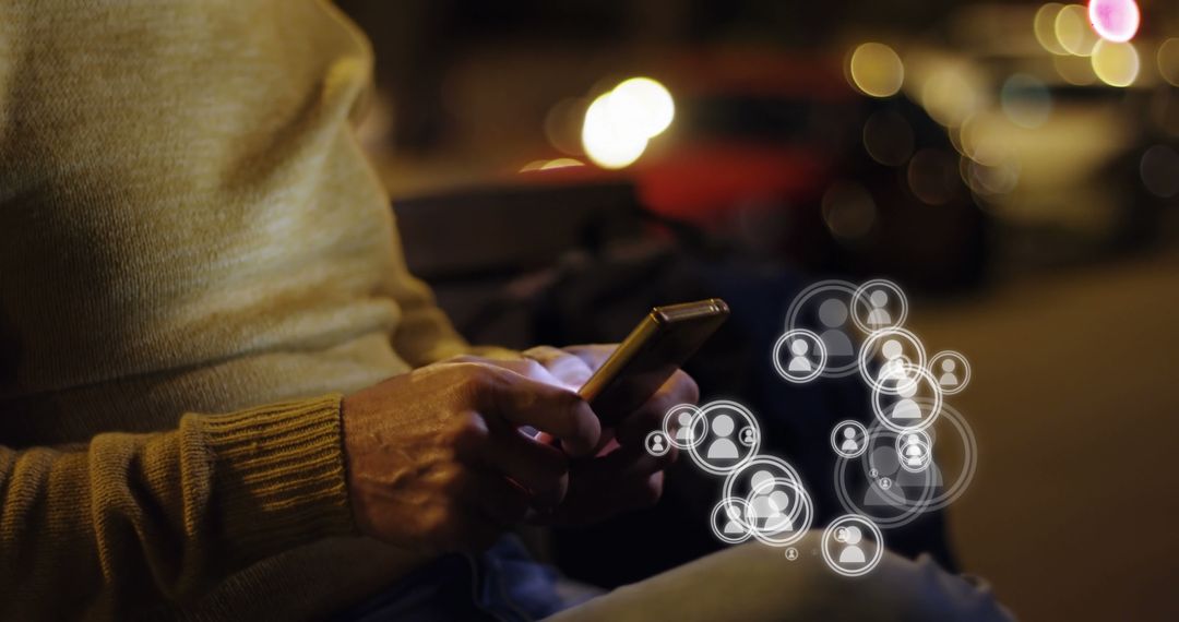 Man Using Smartphone with Social Media Icons in Night Urban Background - Free Images, Stock Photos and Pictures on Pikwizard.com