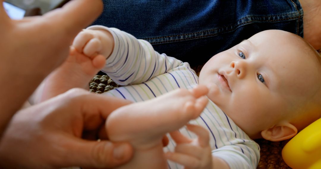 Adorable Infant Lying On Back Holding Feet - Free Images, Stock Photos and Pictures on Pikwizard.com