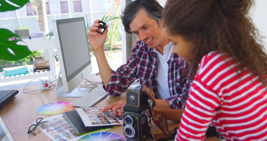 Photographer Teaching Student Darkroom Techniques with Vintage Camera - Free Images, Stock Photos and Pictures on Pikwizard.com