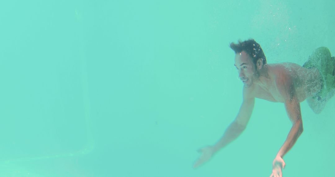 Man Swimming Underwater in Clear Pool - Free Images, Stock Photos and Pictures on Pikwizard.com