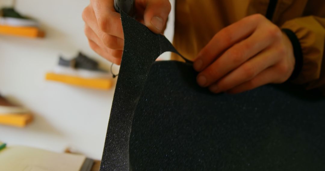 Hands Cutting Black Material for Crafting Project